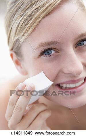 Woman removing makeup smiling View Large Photo Image Stock Photo - Woman removing makeup smiling. Fotosearch
