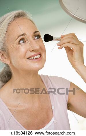 Woman with makeup brush smiling View Large Photo Image Stock Photograph - Woman with makeup brush smiling. Fotosearch