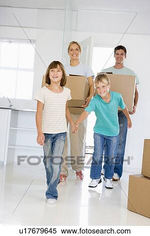 Family with boxes moving into new home smiling View Large Photo Image Stock Photography - Family with boxes moving into new home smiling. Fotosearch