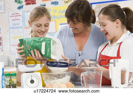 Download Students preparing ingredients in cooking class with teacher Picture | u17224724 | Fotosearch