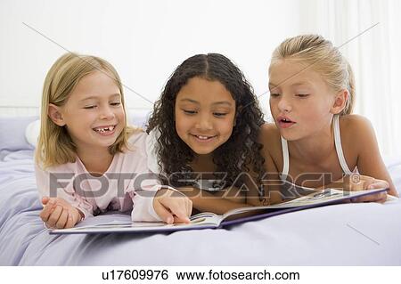 Three Young Girls Lying On A Bed In Their Pajamas View Large Photo Image Stock Photograph - Three Young Girls Lying On A Bed In Their Pajamas. Fotosearch