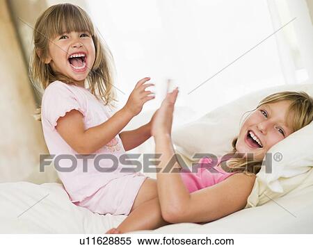 Young Girl Being Woken Up By Her Little Sister View Large Photo Image Stock Photography - Young Girl Being Woken Up By Her Little Sister. Fotosearch