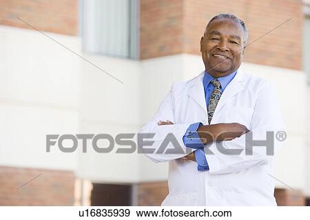 Doctor Standing Outside A Hospital View Large Photo Image Stock Photo - Doctor Standing Outside A Hospital. Fotosearch
