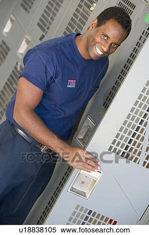 Fireman getting his helmet out of his locker in fire station locker room (depth of field) View Large Photo Image Stock Photography - Fireman getting his helmet out of his locker in fire station locker room (depth of field). Fotosearch