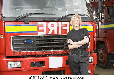 Firewoman standing in front of fire engine View Large Photo Image Stock Image - Firewoman standing in front of fire engine. Fotosearch