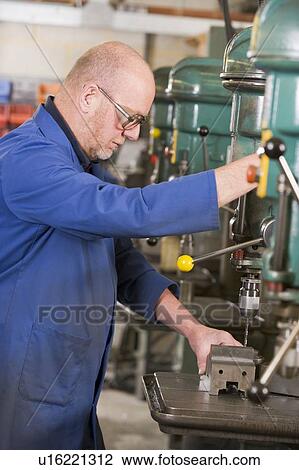 Machinist working on machine View Large Photo Image Stock Image - Machinist working on machine. Fotosearch