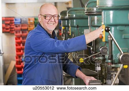 Machinist working on machine View Large Photo Image Stock Image - Machinist working on machine. Fotosearch