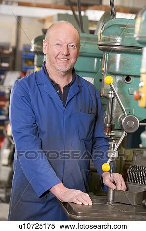 Machinist working on machine View Large Photo Image Stock Photography - Machinist working on machine. Fotosearch
