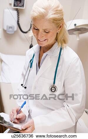 Middle Aged Female Doctor Writing On A Clipboard View Large Photo Image Stock Photograph - Middle Aged Female Doctor Writing On A Clipboard. Fotosearch