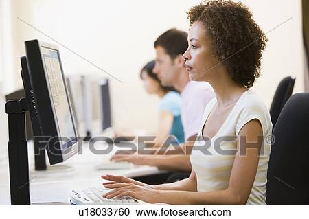 Three people in computer room typing View Large Photo Image Stock Image - Three people in computer room typing. Fotosearch