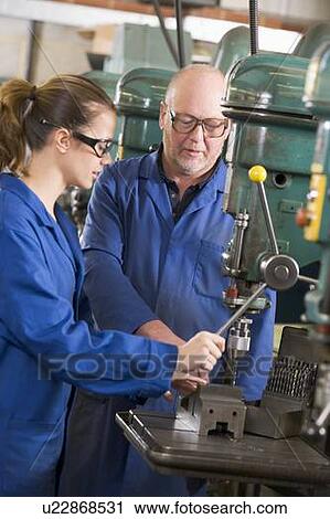 Two machinists working on machine View Large Photo Image Stock Image - Two machinists working on machine. Fotosearch
