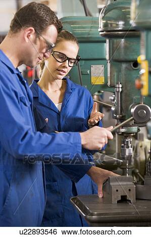 Two machinists working on machine View Large Photo Image Stock Photograph - Two machinists working on machine. Fotosearch