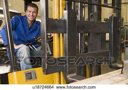 Warehouse worker in forklift View Large Photo Image Picture - Warehouse worker in forklift. Fotosearch