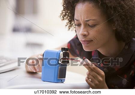 Woman in computer room using pencil sharpener View Large Photo Image Stock Image - Woman in computer room using pencil sharpener. Fotosearch