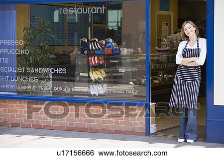 Woman standing in doorway of restaurant smiling View Large Photo Image Stock Photograph - Woman standing in doorway of restaurant smiling. Fotosearch