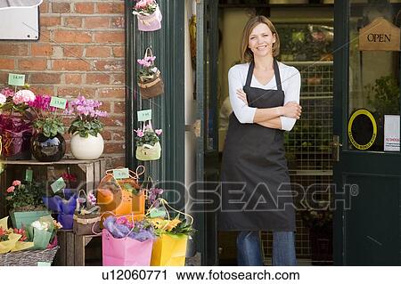 Woman working at flower shop smiling View Large Photo Image Stock Image - Woman working at flower shop smiling. Fotosearch