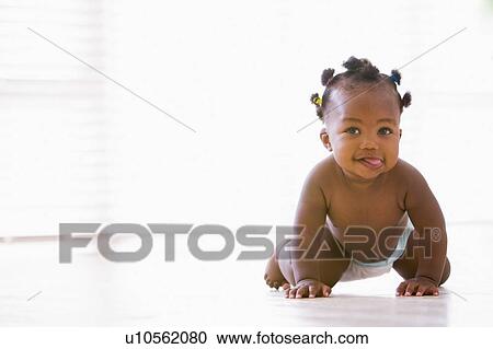 Stock Image - Baby crawling indoors. Fotosearch