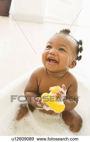 Stock Photo - Baby in bubble bath. Fotosearch