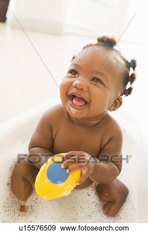 Stock Photo - Baby in bubble bath. Fotosearch