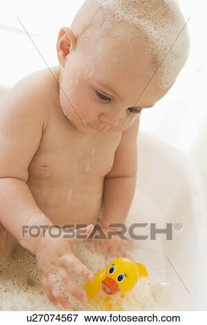 Baby in bubble bath View Large Photo Image Stock Photo - Baby in bubble bath. Fotosearch