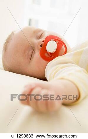 Baby lying indoors sleeping View Large Photo Image Stock Image - Baby lying indoors sleeping. Fotosearch