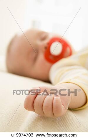 Baby lying indoors sleeping View Large Photo Image Stock Image - Baby lying indoors sleeping. Fotosearch