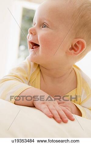 Baby lying indoors smiling View Large Photo Image Picture - Baby lying indoors smiling. Fotosearch