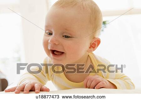 Baby lying indoors View Large Photo Image Stock Image - Baby lying indoors. Fotosearch