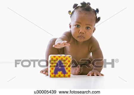 Baby playing with block View Large Photo Image Stock Photo - Baby playing with block. Fotosearch