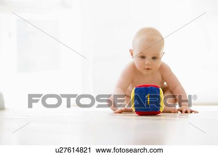 Baby sitting indoors with block View Large Photo Image Stock Image - Baby sitting indoors with block. Fotosearch
