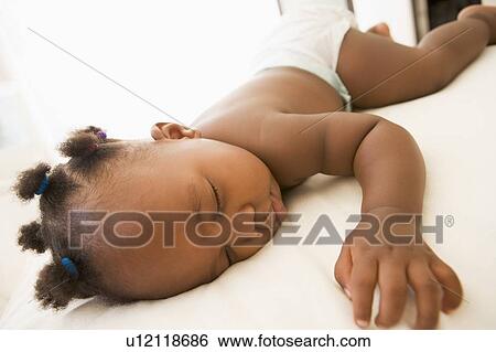 Baby sleeping in bedroom View Large Photo Image Stock Photograph - Baby sleeping in bedroom. Fotosearch