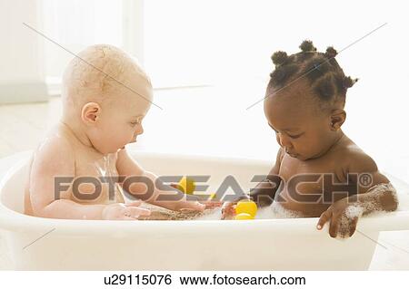 Stock Photograph - Two babies in bubble bath. Fotosearch