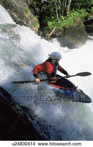 Kayaker in rapids going over waterfall (blur) View Large Photo Image Picture - Kayaker in rapids going over waterfall (blur). Fotosearch