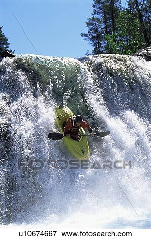 Kayaker in rapids going over waterfall View Large Photo Image Stock Photo - Kayaker in rapids going over waterfall. Fotosearch