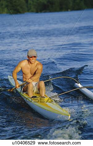 Kayaker rowing in calm waters (selective focus) View Large Photo Image Stock Photo - Kayaker rowing in calm waters (selective focus). Fotosearch