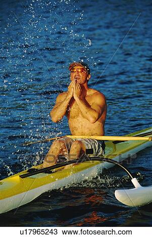 Kayakers sitting in kayak and splashing water on face (selective focus) View Large Photo Image Stock Image - Kayakers sitting in kayak and splashing water on face (selective focus). Fotosearch