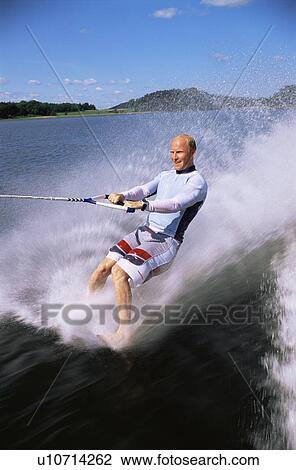 Man bare foot waterskiing View Large Photo Image Stock Image - Man bare foot waterskiing. Fotosearch