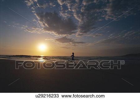 Man outdoors running on a beach at sunset (silhouette) View Large Photo Image Stock Image - Man outdoors running on a beach at sunset (silhouette). Fotosearch