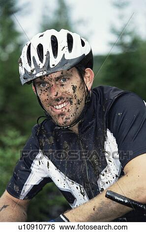 Man outdoors sitting on bicycle dirty and smiling (selective focus) View Large Photo Image Stock Photograph - Man outdoors sitting on bicycle dirty and smiling (selective focus). Fotosearch
