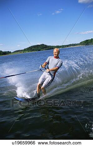 Stock Photograph - Man water skiing. Fotosearch