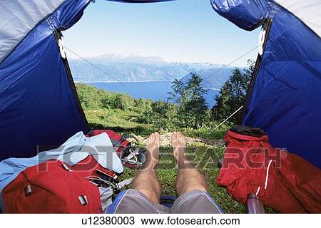 Man's legs in a tent overlooking scenic location View Large Photo Image Stock Image - Man's legs in a tent overlooking scenic location. Fotosearch
