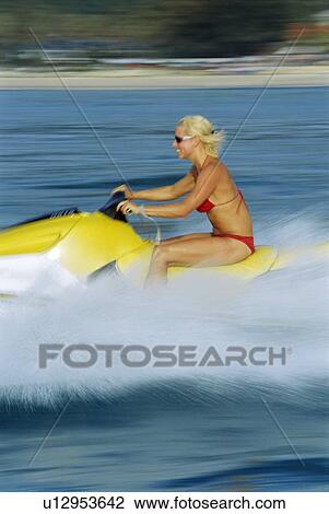 Woman jet skiing and smiling (blur) View Large Photo Image Stock Image - Woman jet skiing and smiling (blur). Fotosearch