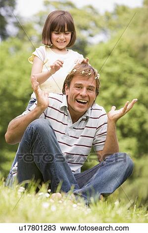 Father and daughter sitting outdoors with flowers smiling View Large Photo Image Stock Image - Father and daughter sitting outdoors with flowers smiling. Fotosearch