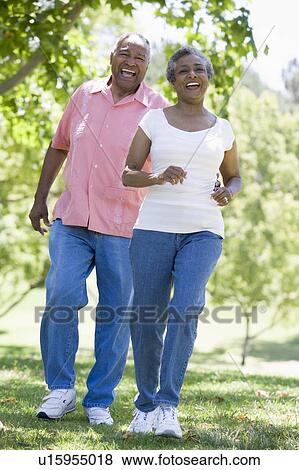 Senior couple walking in park together View Large Photo Image Stock Photo - Senior couple walking in park together. Fotosearch