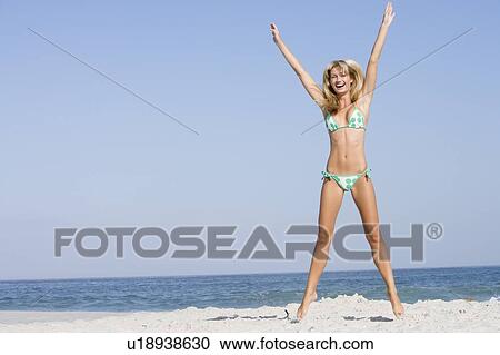Woman in a two piece bathing suit posing on a beach View Large Photo Image Stock Image - Woman in a two piece bathing suit posing on a beach. Fotosearch