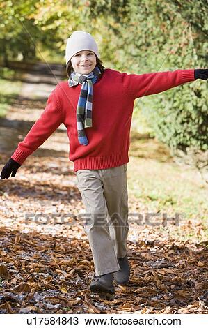 Young boy outdoors at park running on path and smiling (selective focus) View Large Photo Image Stock Image - Young boy outdoors at park running on path and smiling (selective focus). Fotosearch