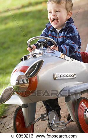 Young boy playing outdoors in airplane smiling View Large Photo Image Stock Image - Young boy playing outdoors in airplane smiling. Fotosearch