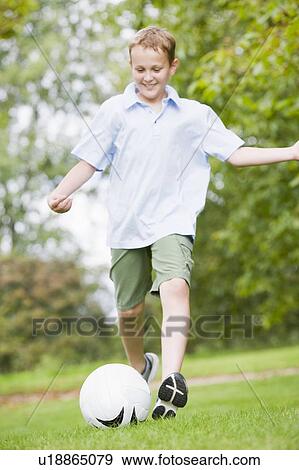 Young boy playing soccer View Large Photo Image Stock Photo - Young boy playing soccer. Fotosearch
