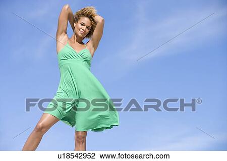 Young woman posing outdoors View Large Photo Image Stock Image - Young woman posing outdoors. Fotosearch