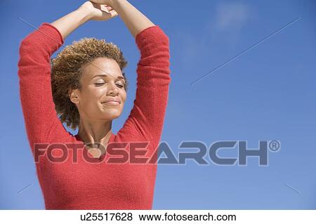 Stock Photo - Young woman posing outdoors. Fotosearch